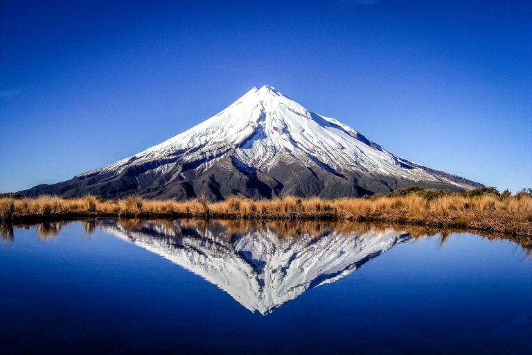 Mount Taranaki with a lake in the foreground